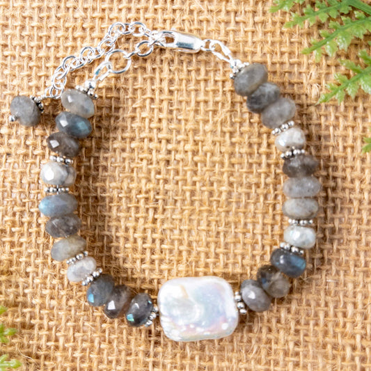 The bracelet features a baroque pearl focal that is surrounded by labradorite and moonstone faceted rondelle beads.  With the extender if will accommodate a 6.5 to 8 inch wrist