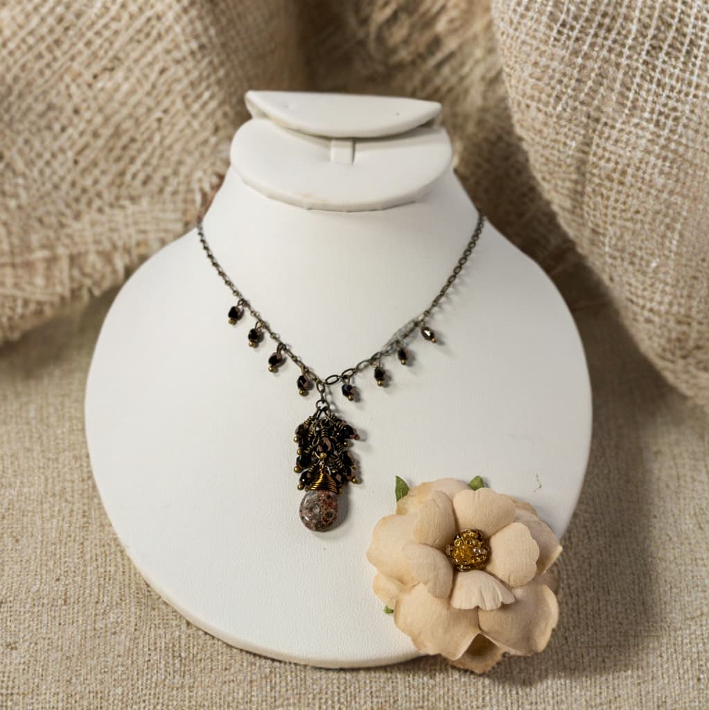 This necklace is 18 inches and includes a 2 inch extender. A teardrop leopard jasper bead is wire wrapped with antique bronze wire and accented with Czech glass bead dangles.