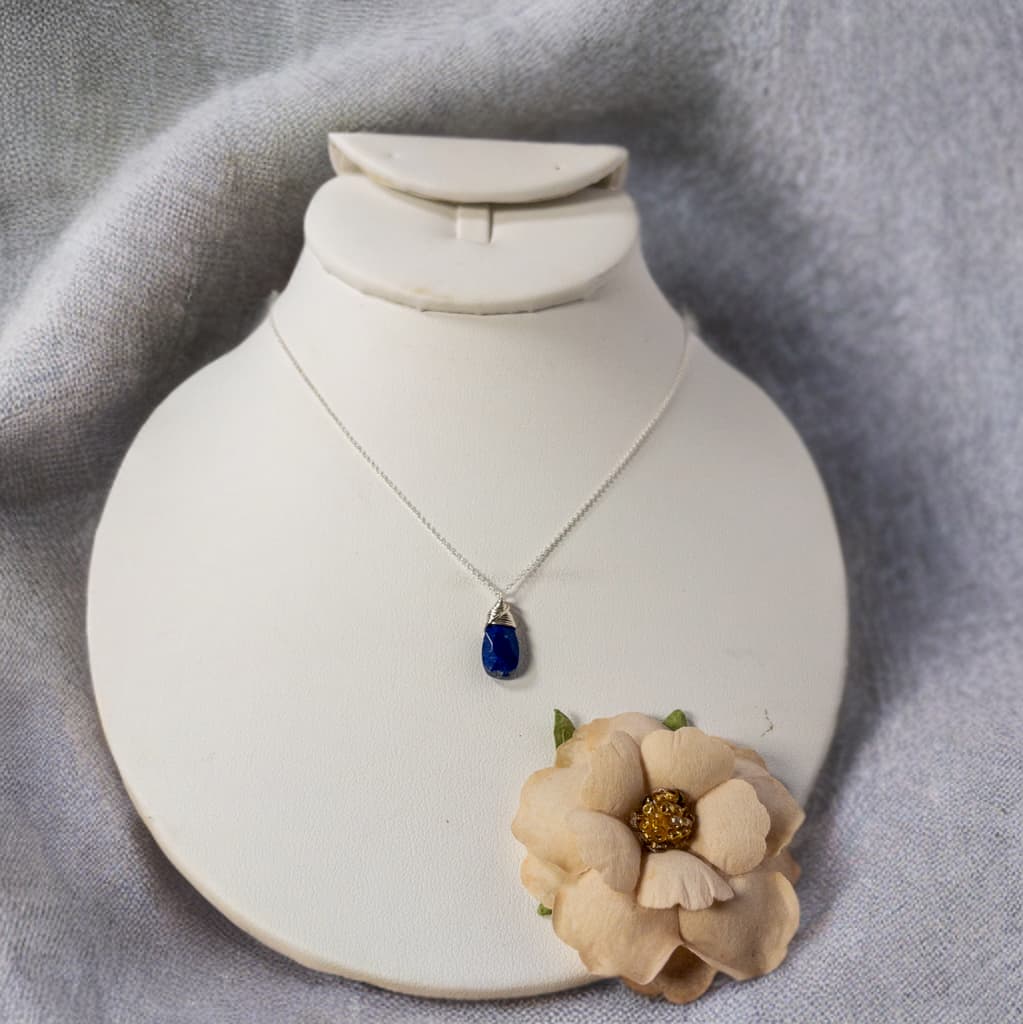 This necklace is 16 inches in length and features dainty sterling silver cable chain. A single faceted tear drop lapis bead hangs from the chain.