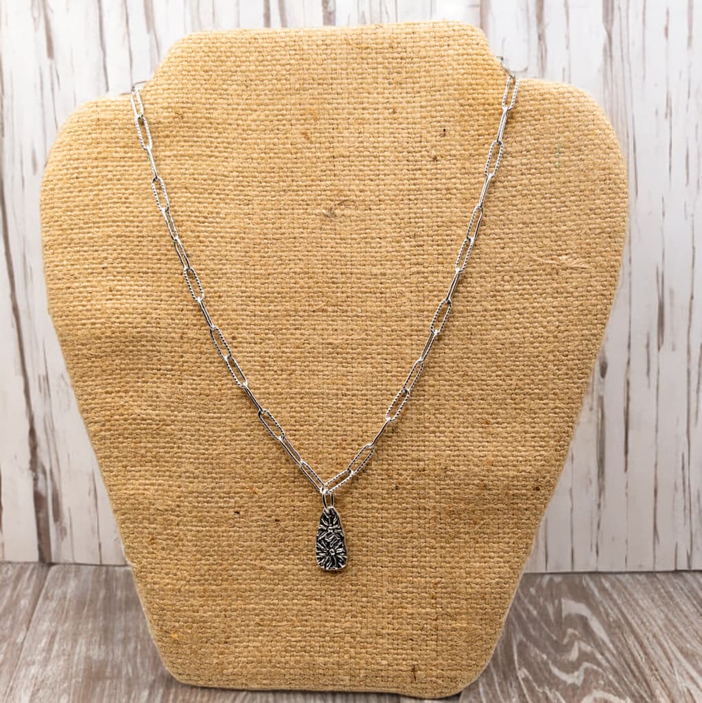 18 inch paper clip chain necklace with a single charm.