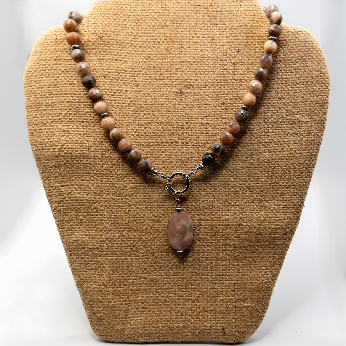 This pendant necklace is made with faceted black and peach moonstones. It includes a removable faceted oval peach moonstone.