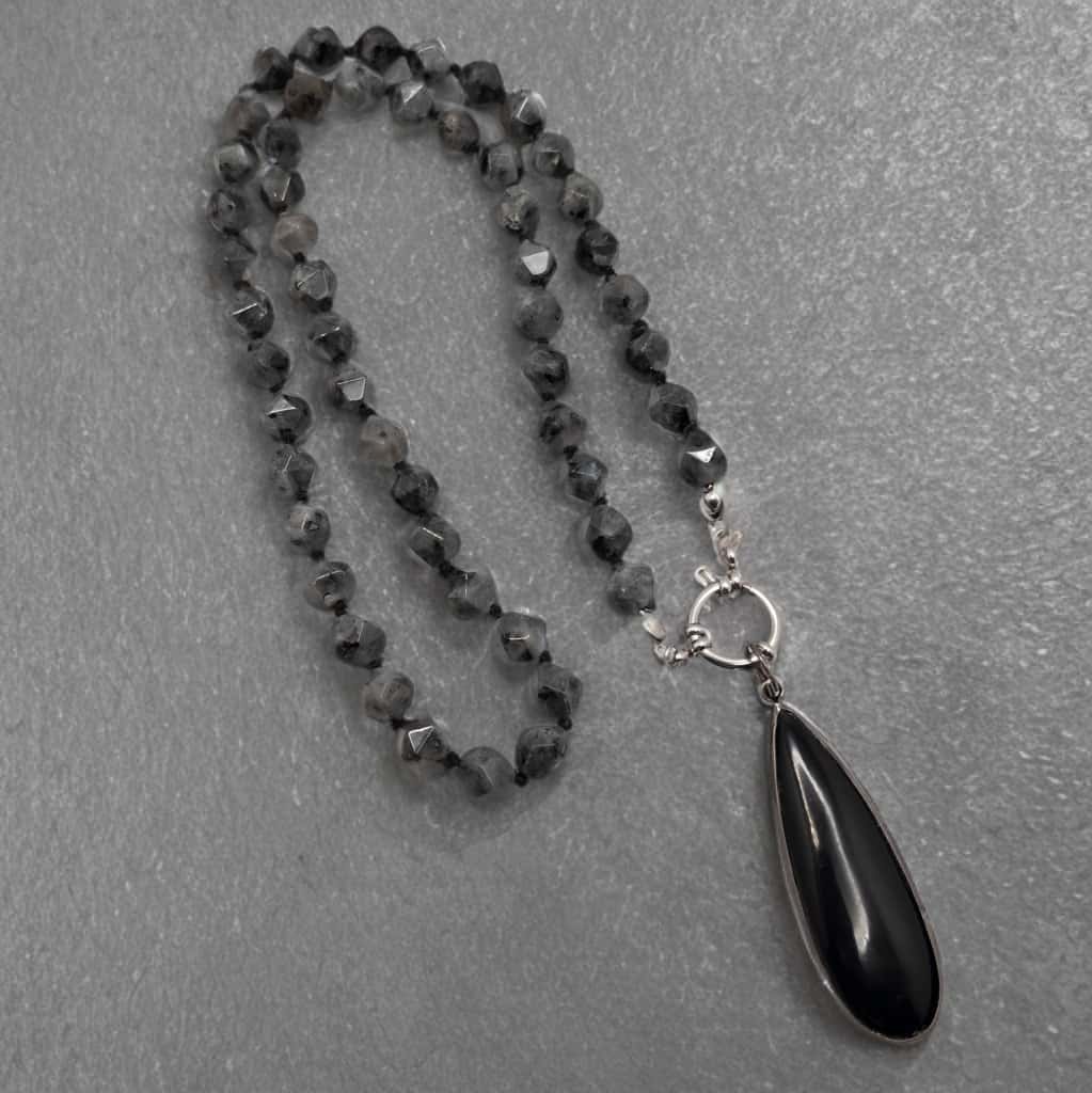 20 inch hand knotted larvikite pendant necklace. It includes a removable bezeled teardrop black onyx pendant.