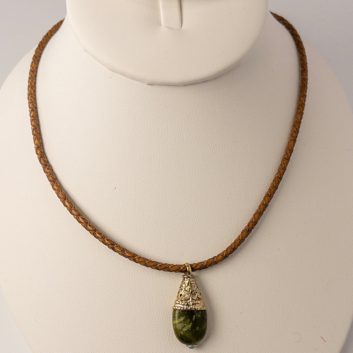 This necklace is made with 3mm braided leather cording and includes a "nepalese" inspired pendant focal.