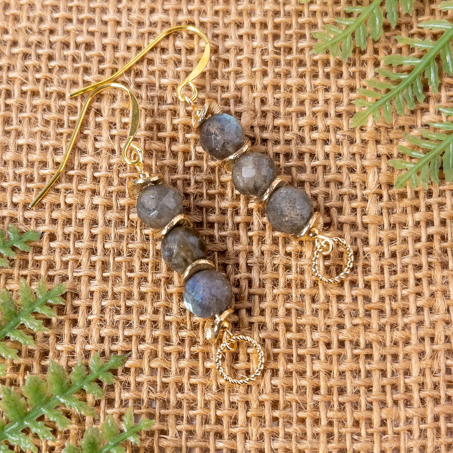 These earrings measure approximately 1.5 inches and are made with faceted round labradorite beads that are accented with wavy spacer beads