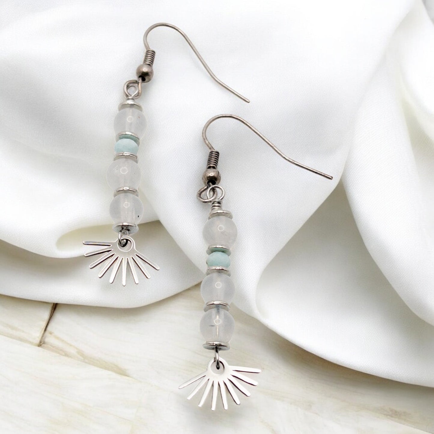 Pair of beaded earrings made with blue moonstone and larimar with sunburst charms