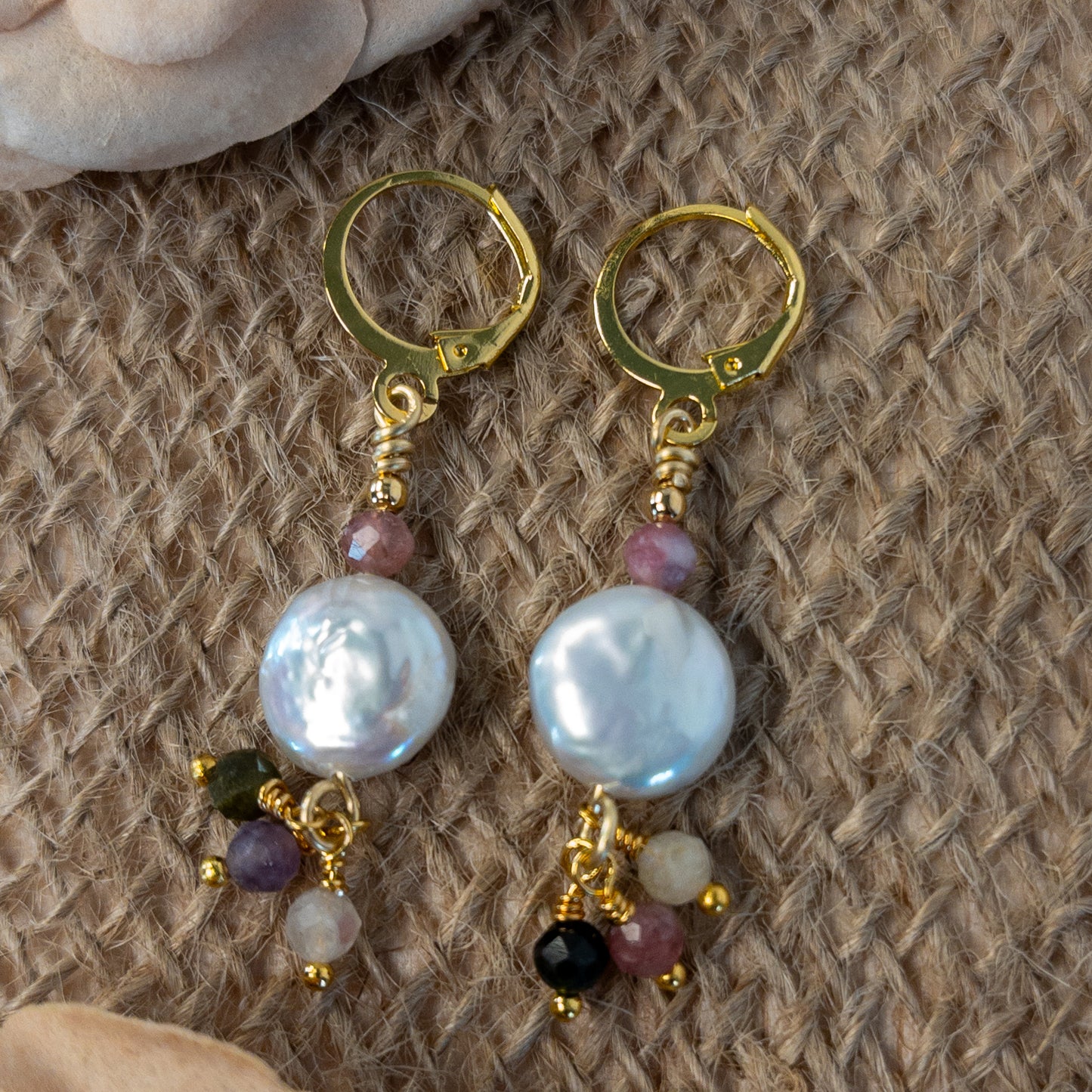 These earrings are made from coin shaped pearls and tourmaline small faceted beads. The tourmaline beads hang from the bottom of the coin pearl creating a dangle.
