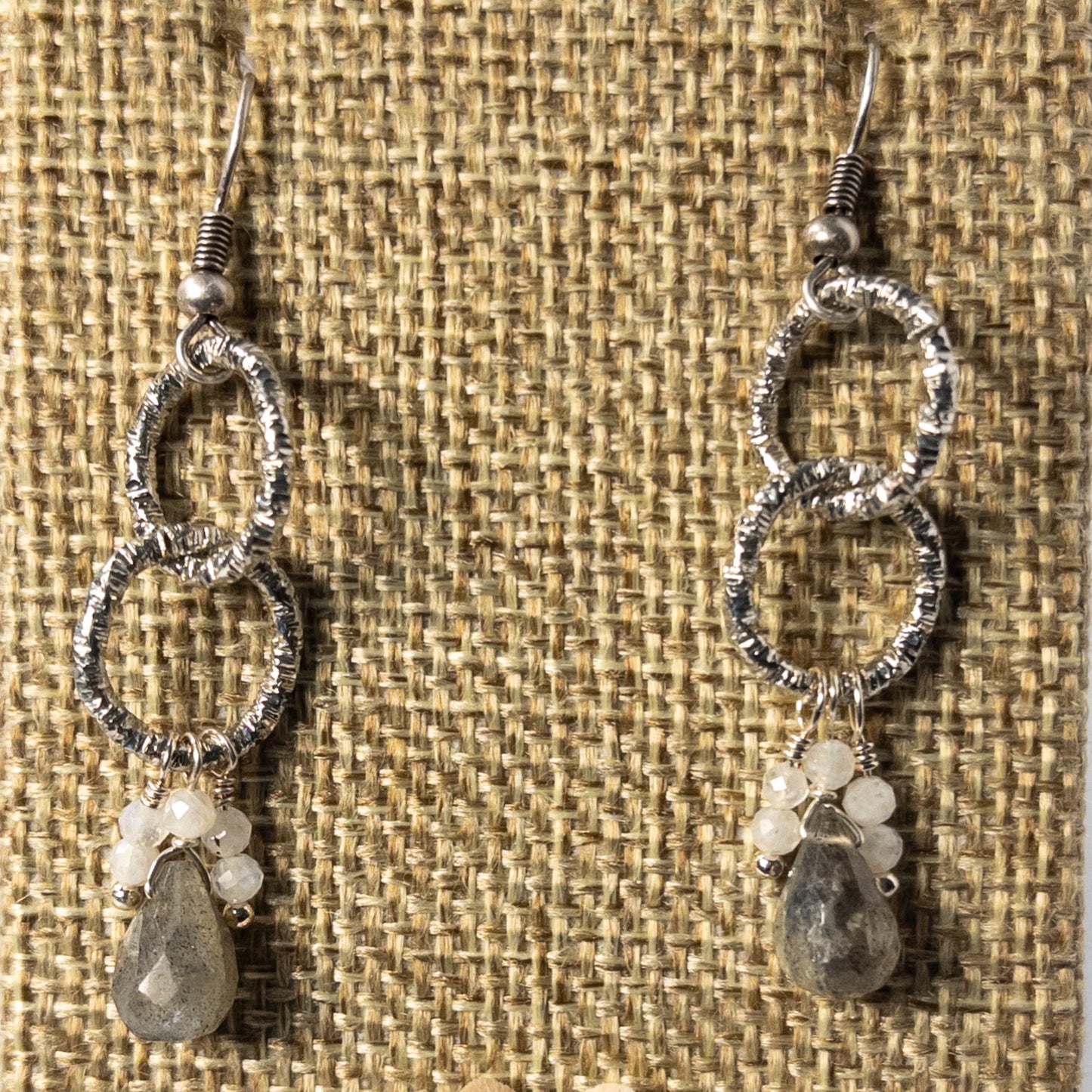 These 1.5 inch drop earrings feature the mesmerizing properties of labradorite and the ethereal beauty of moonstone beaded dangles. Labradorite briolette beads and moonstone dangle beads are suspended from chain to create a stunning pair of earrings