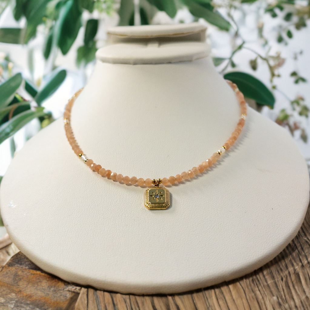 This necklace features 3mm faceted peach moonstone beads along with small rice pearls. It includes a square starburst charm . It is 16 inches but can be expanded using the 2 inch extender