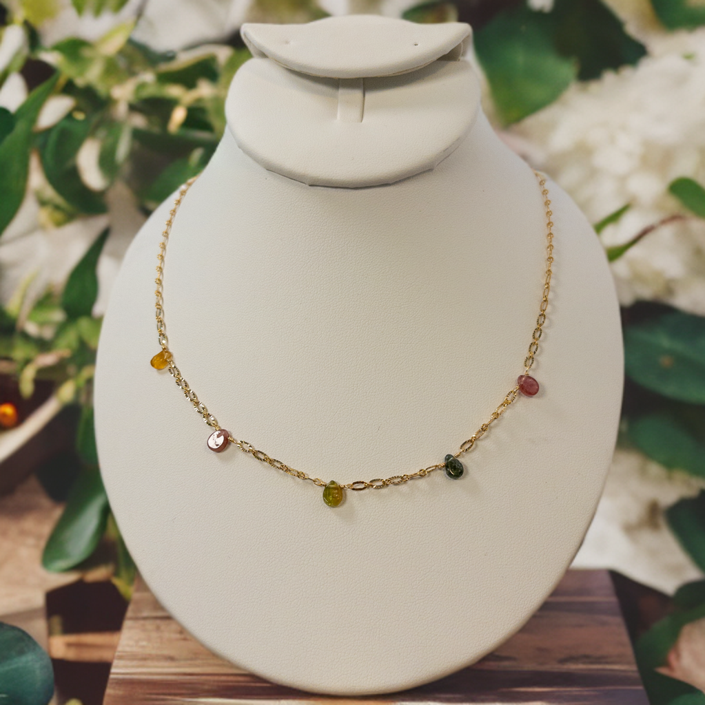 This necklace is made with tear drop shaped tourmaline beads that are individually strung on gold chain.