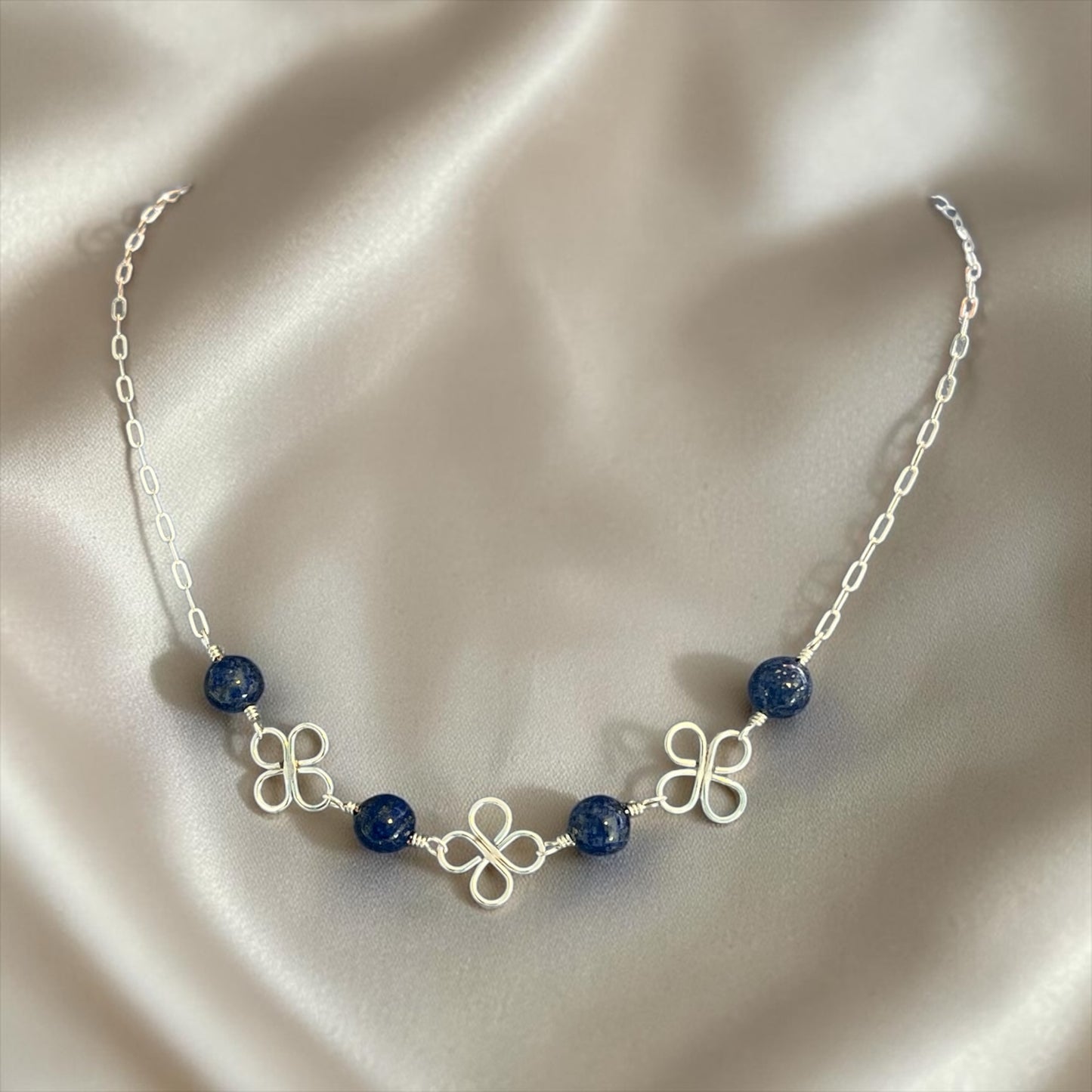 Blakeley Lane Jewelry silver chain necklace with midnight-blue beaded stones and intricate clover-inspired wire motifs.