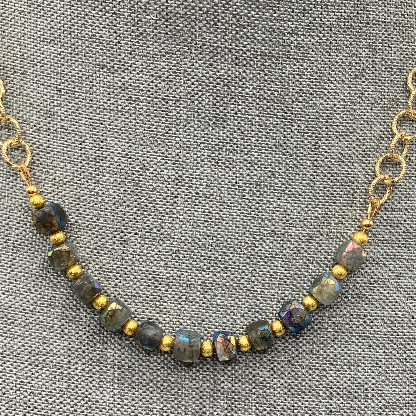 This necklace is made with Labradorite cube beads and gold spacers. The necklace is 20" long.