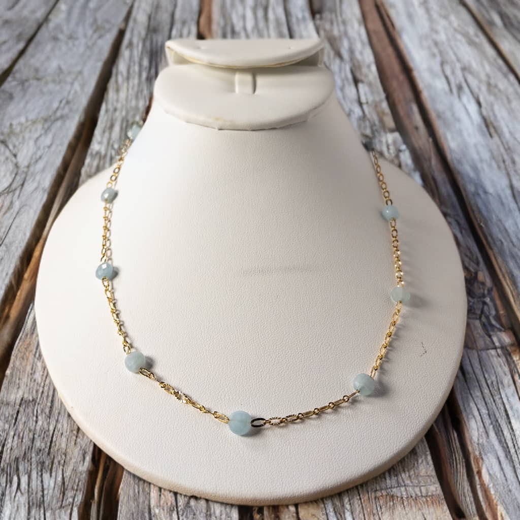  Handcrafted with a combination of 8mm gold plated oval chain and faceted aquamarine beads, this timeless piece can be worn alone or layered. With a 16 inch length and 2 inch extender, it's perfect for staying on trend. 