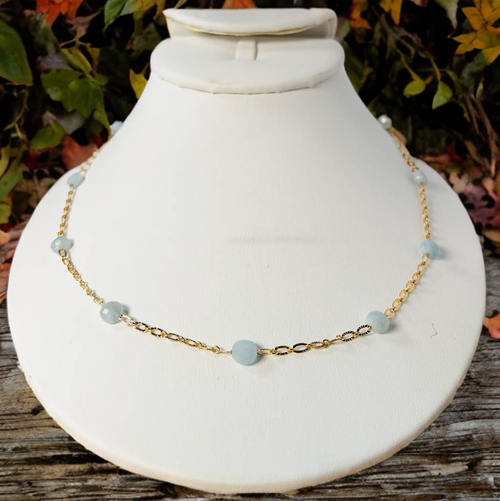  Handcrafted with a combination of 8mm gold plated oval chain and faceted aquamarine beads, this timeless piece can be worn alone or layered. With a 16 inch length and 2 inch extender, it's perfect for staying on trend. 