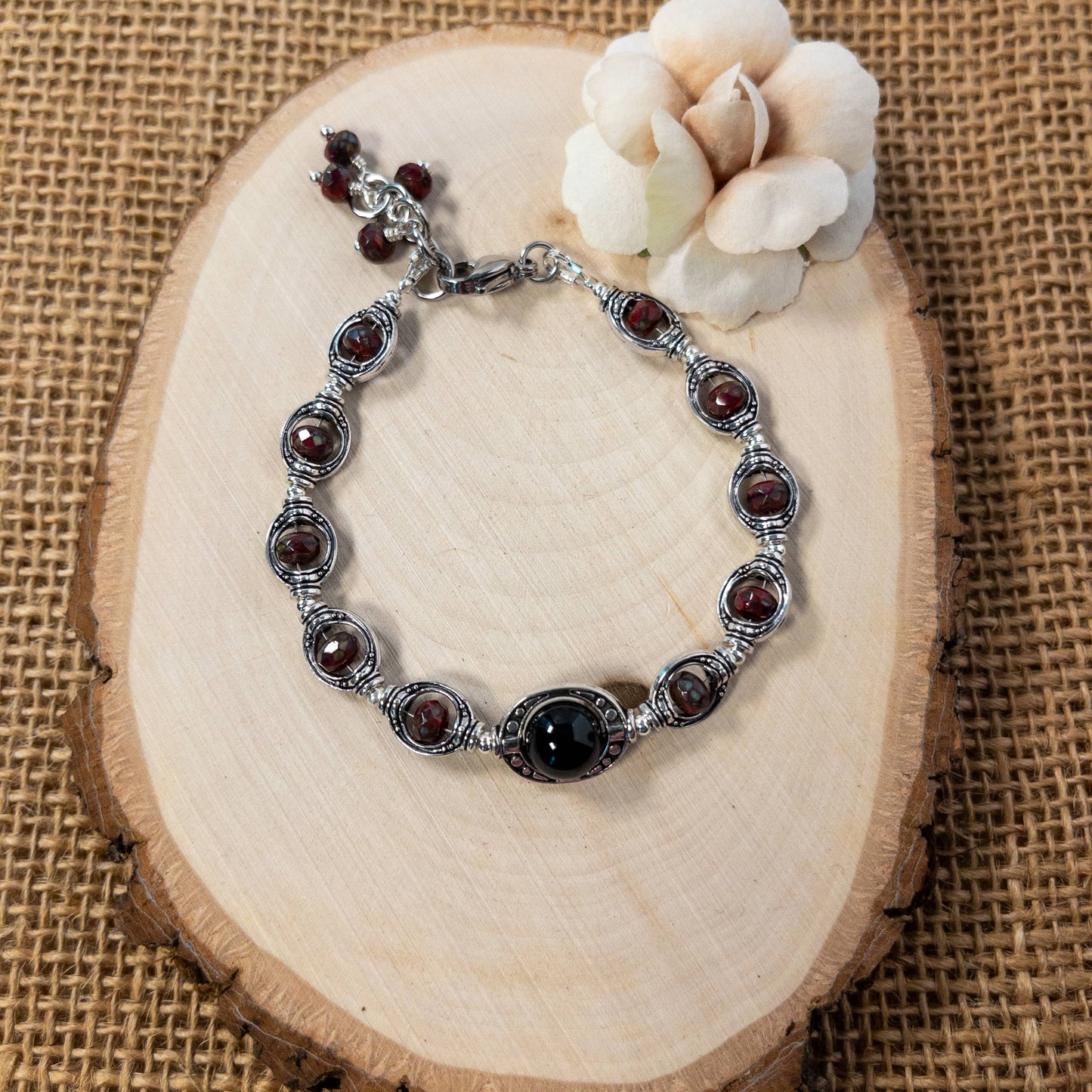 This bracelet features black onyx and Czech beads that are enclosed in silver tone bead frames.  It will accommodate multiple wrist sizes as it included an extender. 