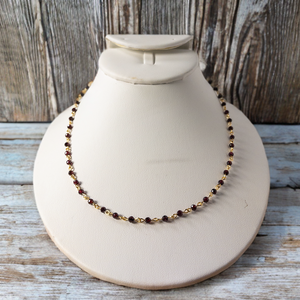 This necklace is created from anti-tarnish gold wire and 3mm faceted garnet beads.  Individual beaded units result in a 16 inch necklace that can be worn alone or layered.  It includes a 2 inch extender which extends the options for wearing
