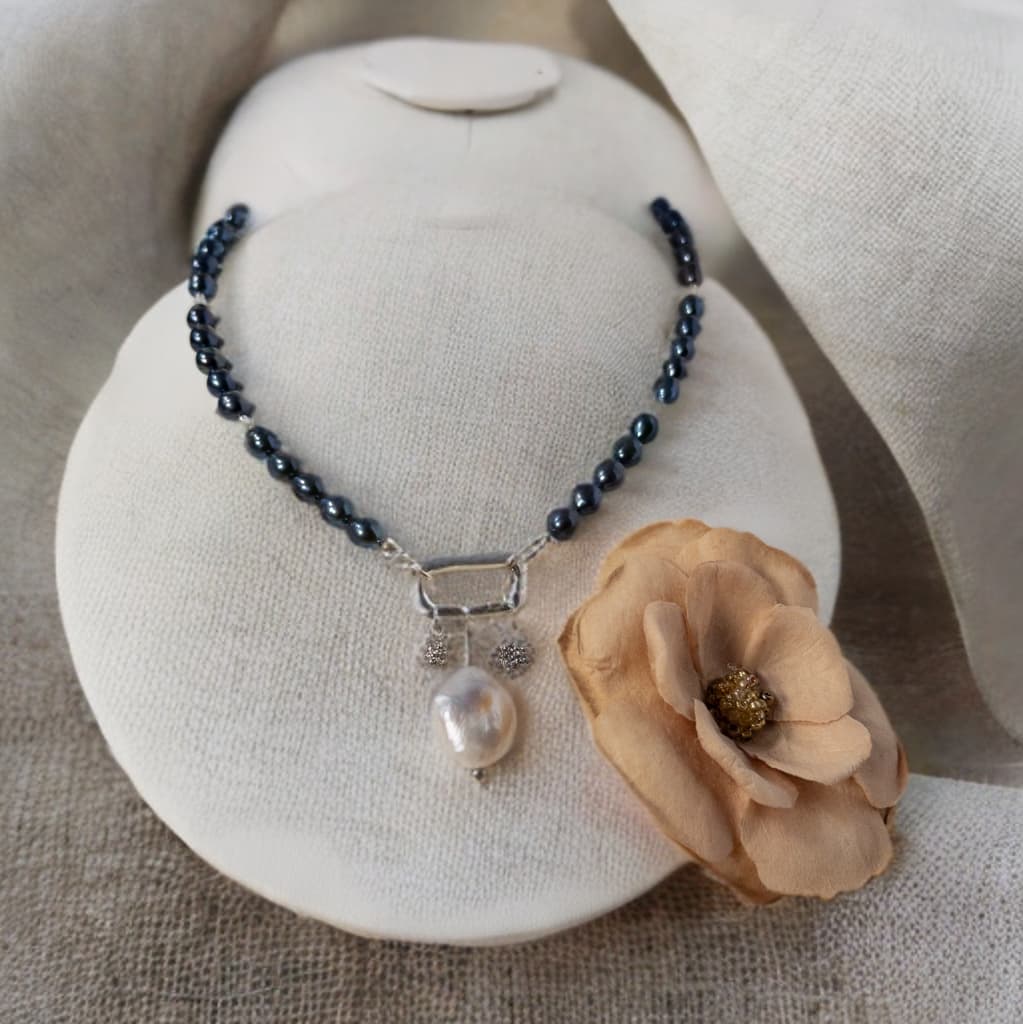 This is a 16 inch necklace made with blue iris pearls and accented with small found moonstone beads.  It includes a carabiner clasp and 3 charms.  Charms can easily be removed for a different look.
