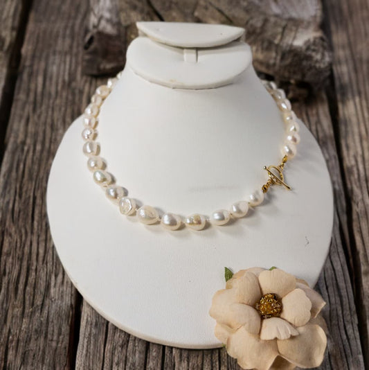 This is a 20 inch hand knotted fresh water pearl necklace.  It includes a gold tone toggle clasp and can be worn in a variety of ways.
