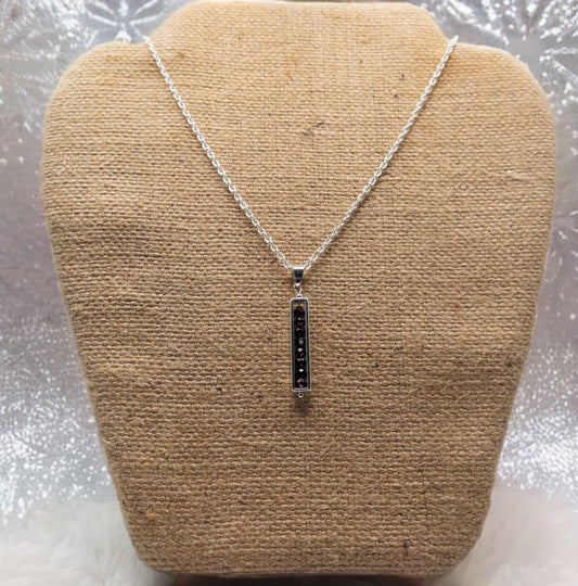 18 inch sterling silver cable chain with a pendant made of 3mm faceted garnet beads enclosed in a silver tone bead frame.
