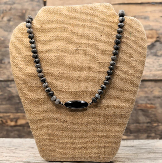 Hand knotted with silk cording and is 18 inches in length with a 3 inch extender.  Black labradorite rondelle shaped beads with a faceted black onyx pendant with gun metal bezel.