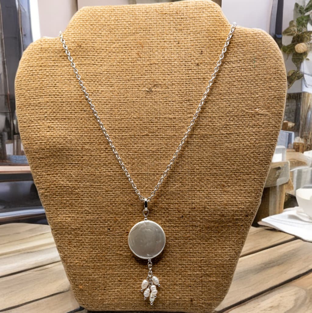 16 inch sterling silver cable chain with 2 inch extender that highlights a 25mm coin pearl with rice pearl dangles.  The coin pearl pendant can be removed easily which extends your wearing options. 