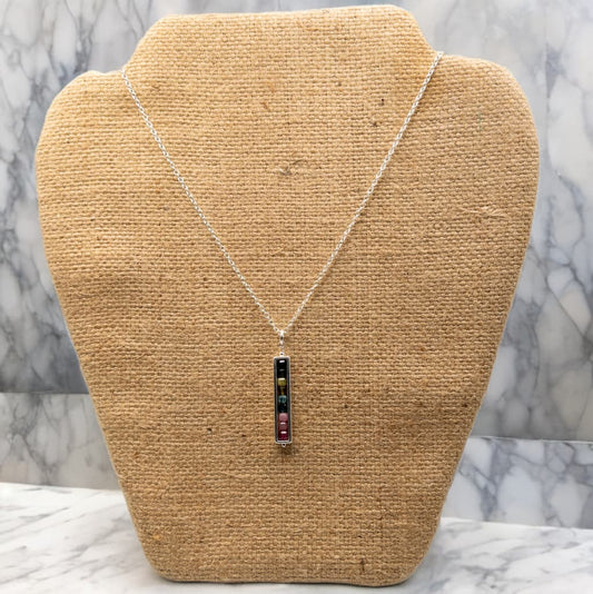 This is a 16 inch, but expandable to 18 inch length sterling silver cable chain necklace.  It includes a single pendant of cube shaped tourmaline beads enclosed in a silver tone rectangle bead frame. 