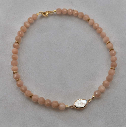 Necklace is 16 inches with a 2 inch extender and is made from faceted 6mm round peach moonstone beads.  The focal is a fresh water pearl bezel.  