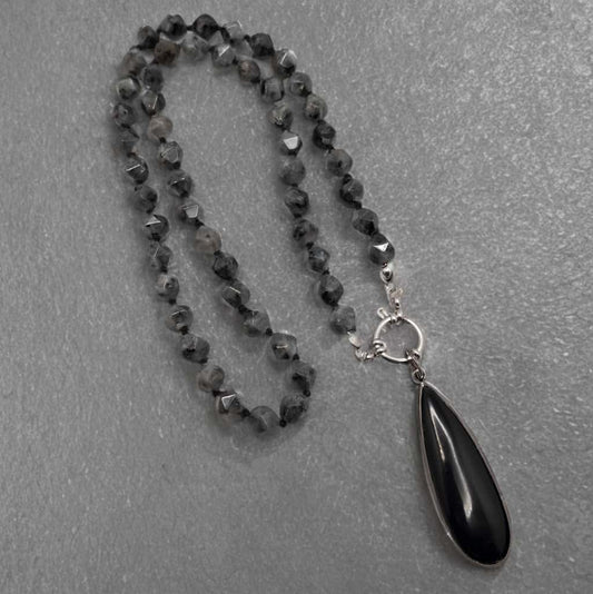 20 inch hand knotted larvikite pendant necklace.  It includes a removable bezeled teardrop black onyx pendant. 
