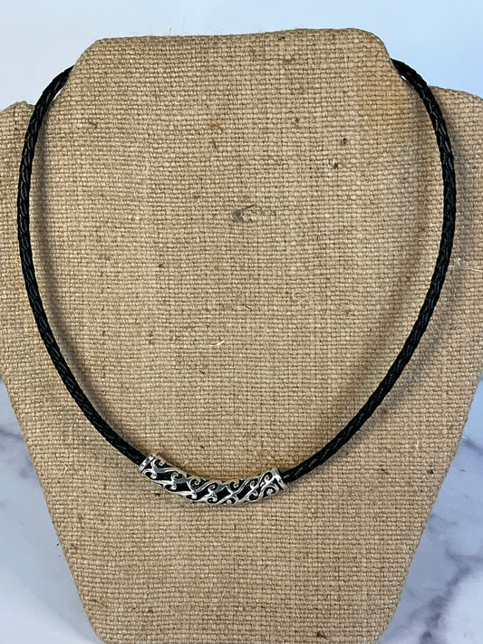 This necklace is made with black braided leather and feather a silver tone slider,  It is 18 inches in length but also has a 2 -inch extender.