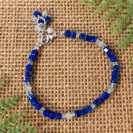 This bracelet fits a 6.5 to 7.5 inclh wrist.  It is made with cube shaped lapis beads that are accented with silver tone spacer beads and moonstone beads.  The lobster clasp is sterling silver