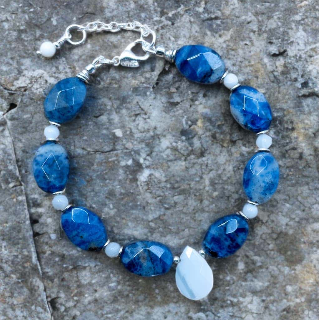 This is a seven inch bracelet with a 1 inch extender that is made from oval shaped sodalite beads.  The sodalite beads are separated or accented by small round mother of pearl beads.  The focal is a tear drop shaped mother of pearl bead.  