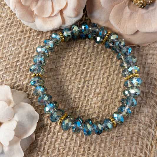 This is a two-strand stretch bracelet.  It is made with crystal rondelles that are slate blue, iris and green.  The two-strands are maintained by daisy spacer bars.  The faceting of the crystals ensure maximum sparkle