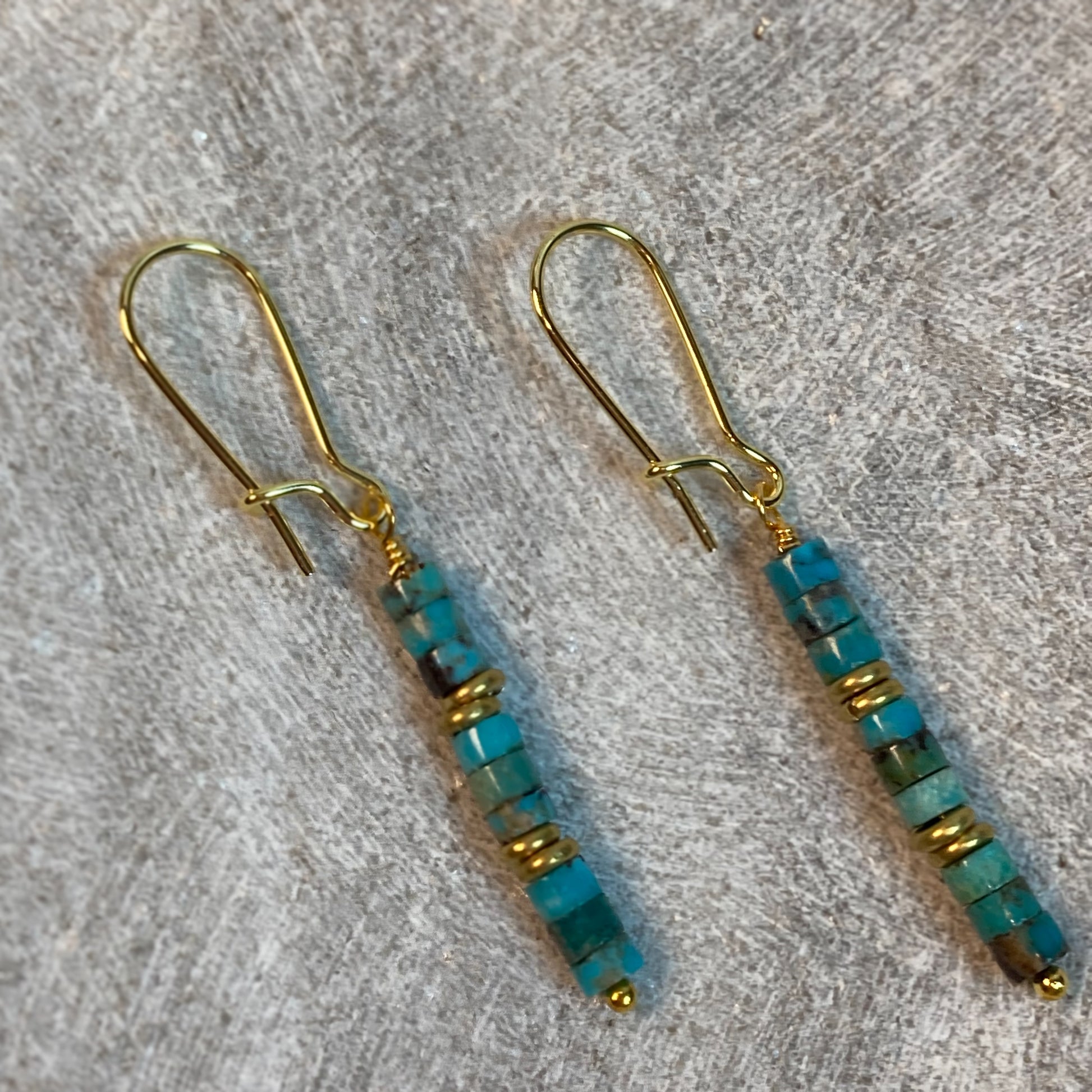 These beautiful Turquoise Wheel Earrings will add some natural and rustic flavor to your look. The unique combination of turquoise wheel beads, brass heishi spacers and kidney earwires creates a unique style that is sure to turn heads.