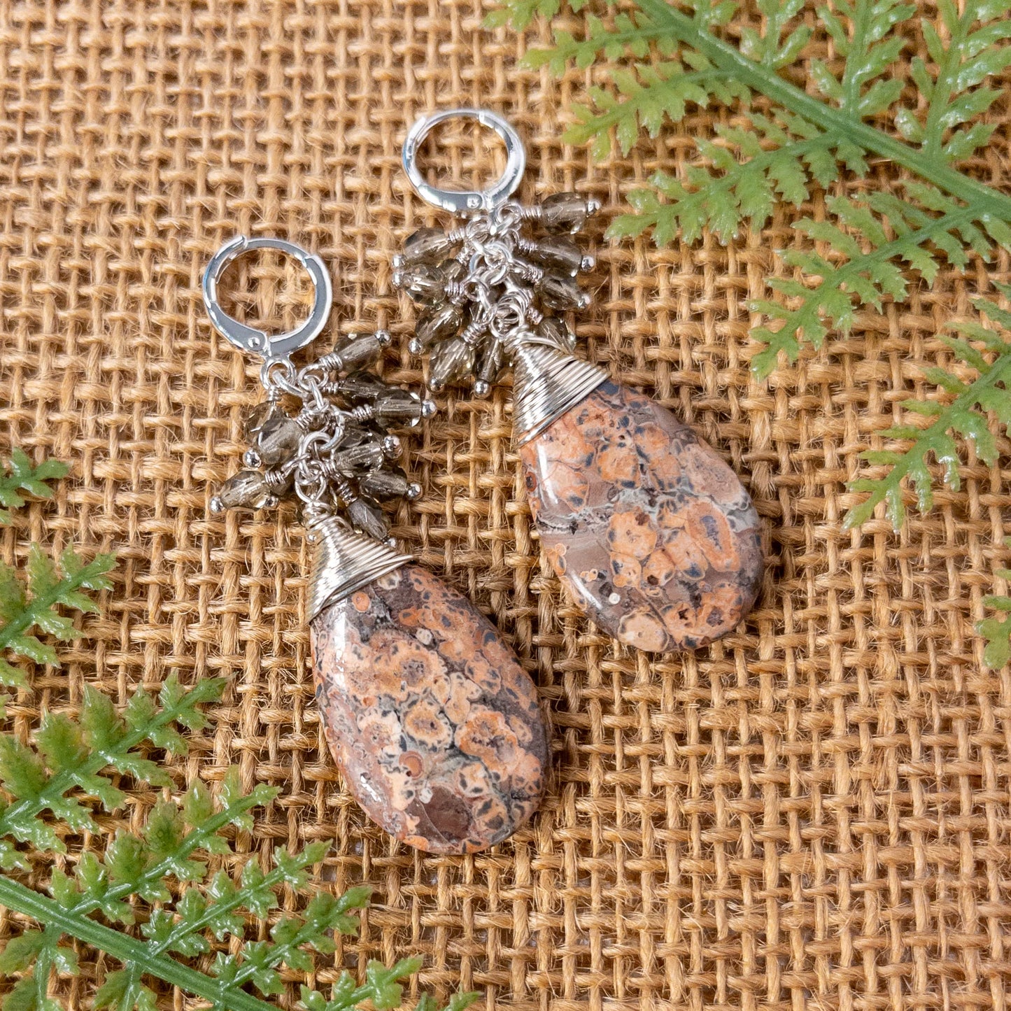 These are pear shaped beads with tones of  light pink and brown.  They are wire wrapped and include grey faceted Czech bead dangles 