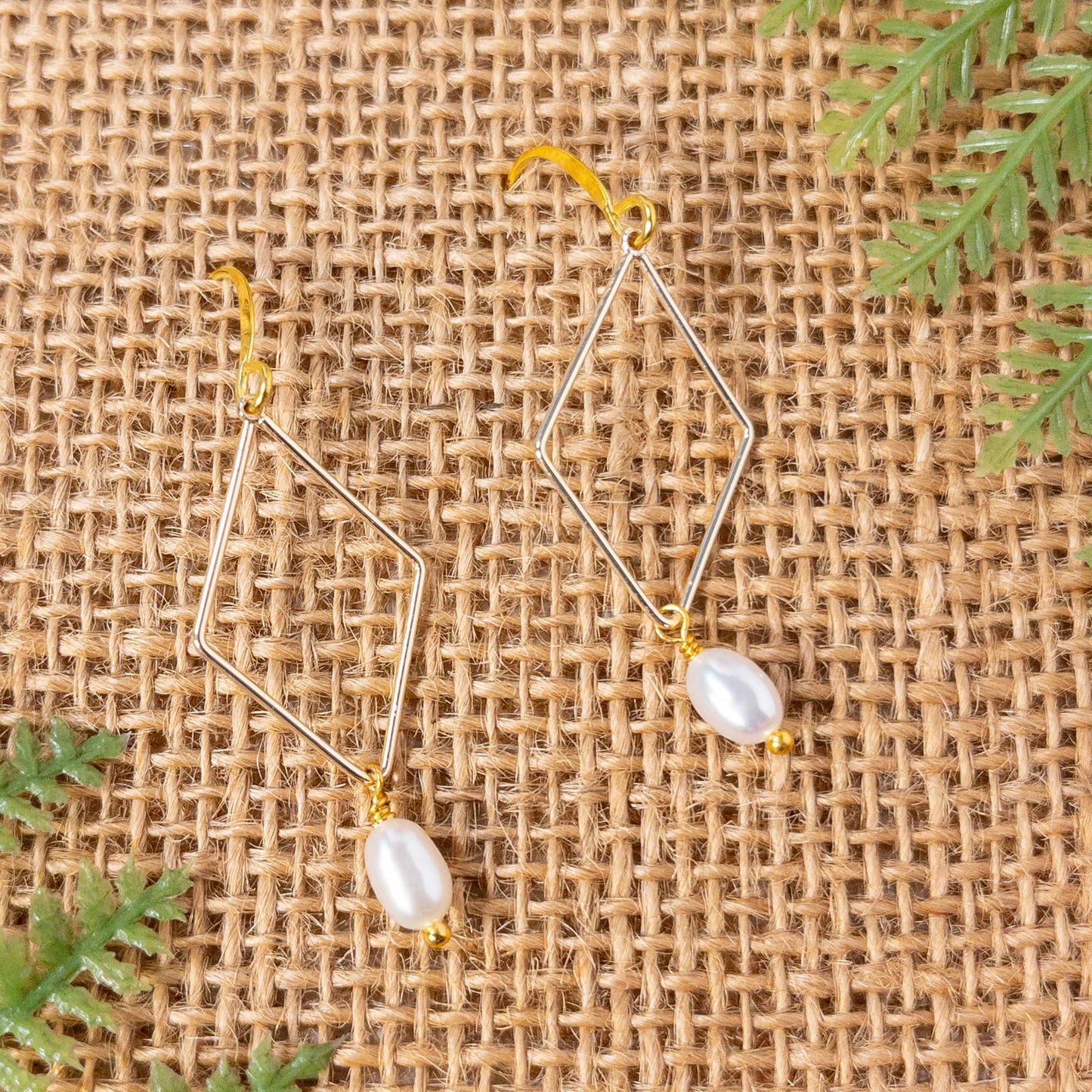 These earrings are approximatel 1.5 inches in length.  Small white pearls hang from gold tone rhombus shaped compnents
