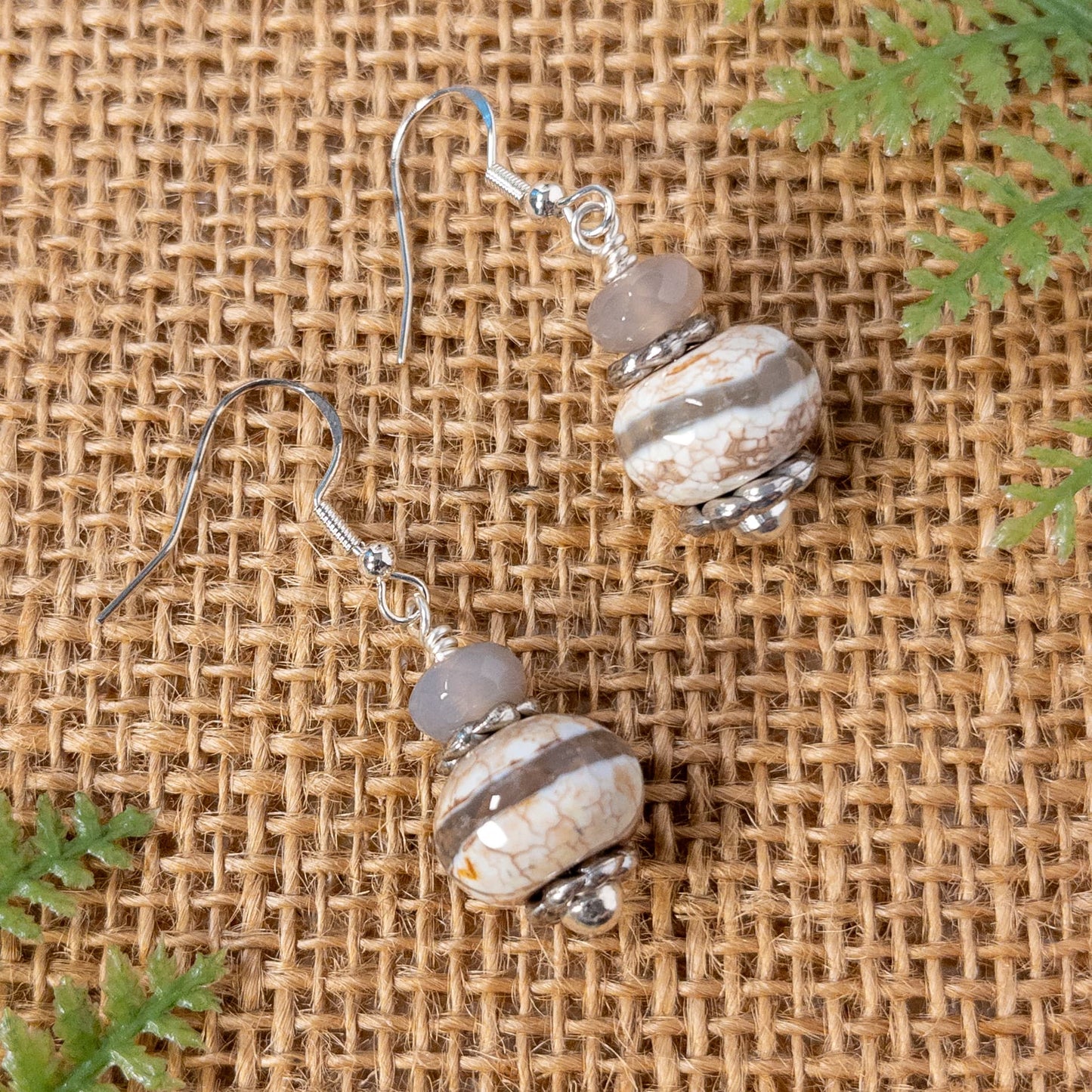 These earrings are made with chunky agate beads that are cream,  with a grey stripe.  A faceted smokey grey agate bead accents and highlights the focal bead
