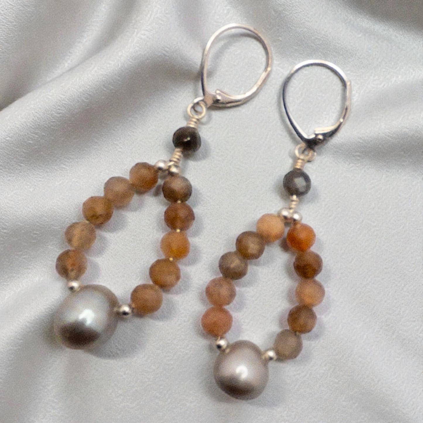 Hoop style earring created using grey and peach moonstone beads with a grey focal bead.  