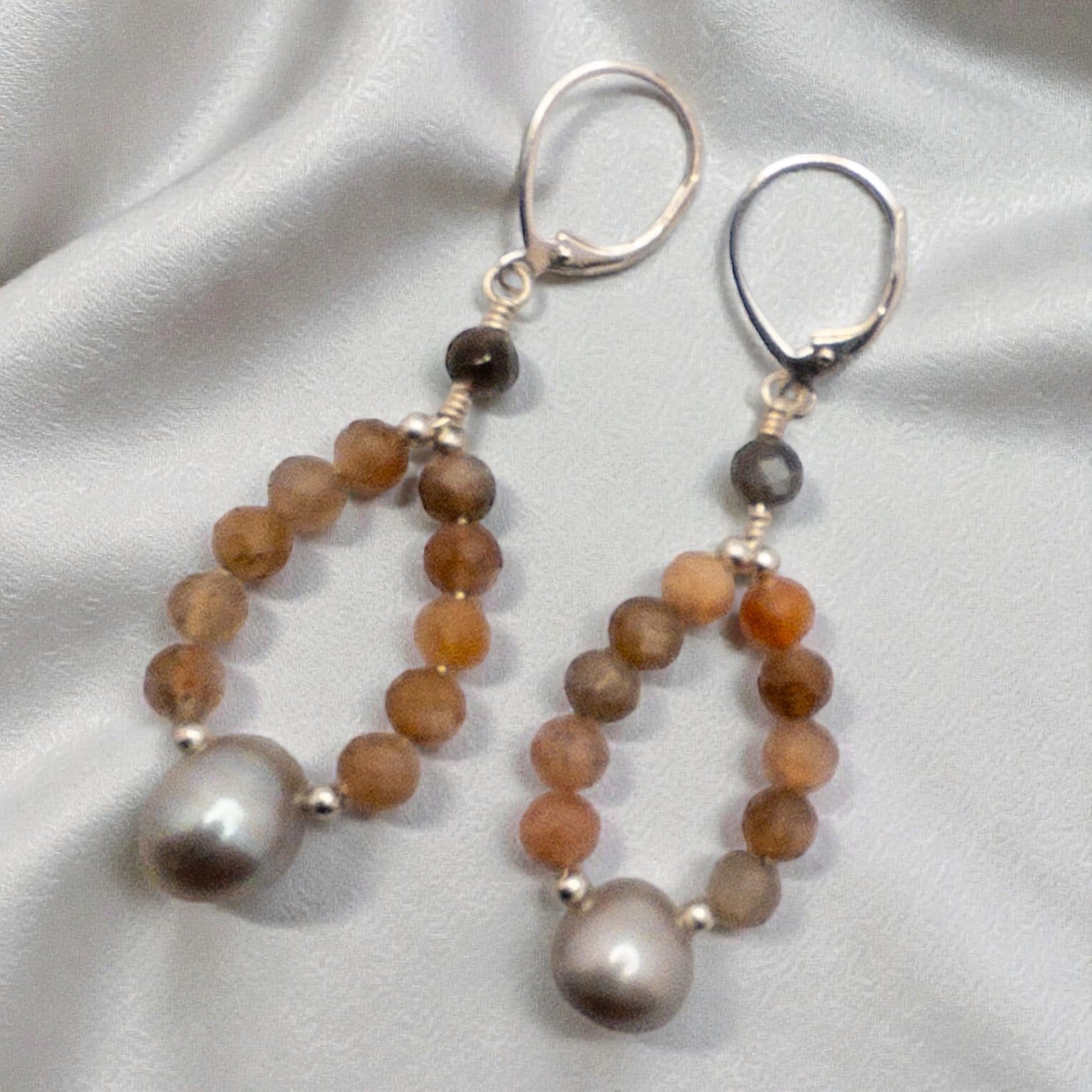 Hoop style earring created using grey and peach moonstone beads with a grey focal bead.  