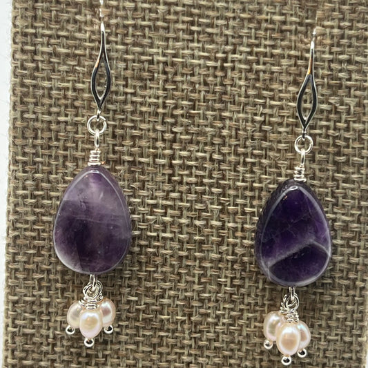 Amethyst tear-drop shaped 14mm gemstones are accented with 3 small rice pearl dangles.  The ear wires are silver and the earrings are approximately 1.5 inches in length