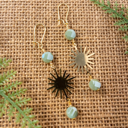 These earrings are approximately 2 inches in length and are made with faceted olive shimmer glass beads and a brass tone sunburst component.  They include gold tone kidney earwires