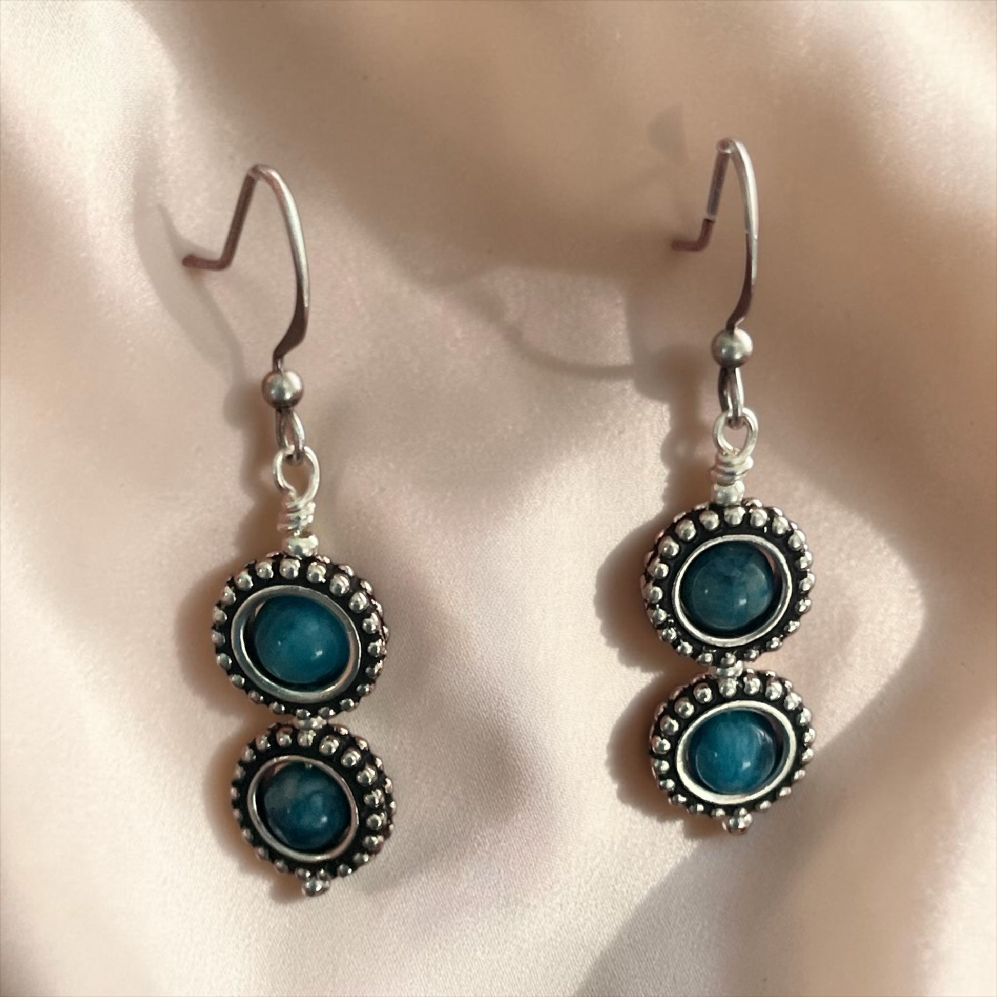 Blakeley Lane Jewelry double-stacked drop earrings with blue cabochon stones and oxidized sterling silver beaded frames.