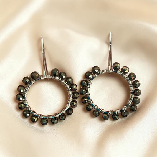 Blakeley Lane Jewelry handcrafted circular hoop earrings with faceted dark metallic beads on silver-tone wire frames.
