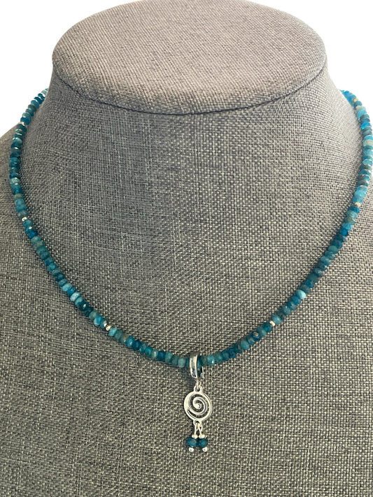 Blakeley Lane Jewelry blue apatite beaded necklace with a silver spiral pendant on a grey display bust.