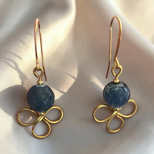 Blakeley Lane Jewelry drop earrings featuring deep blue marbled beads and gold-toned floral wirework on silk fabric.