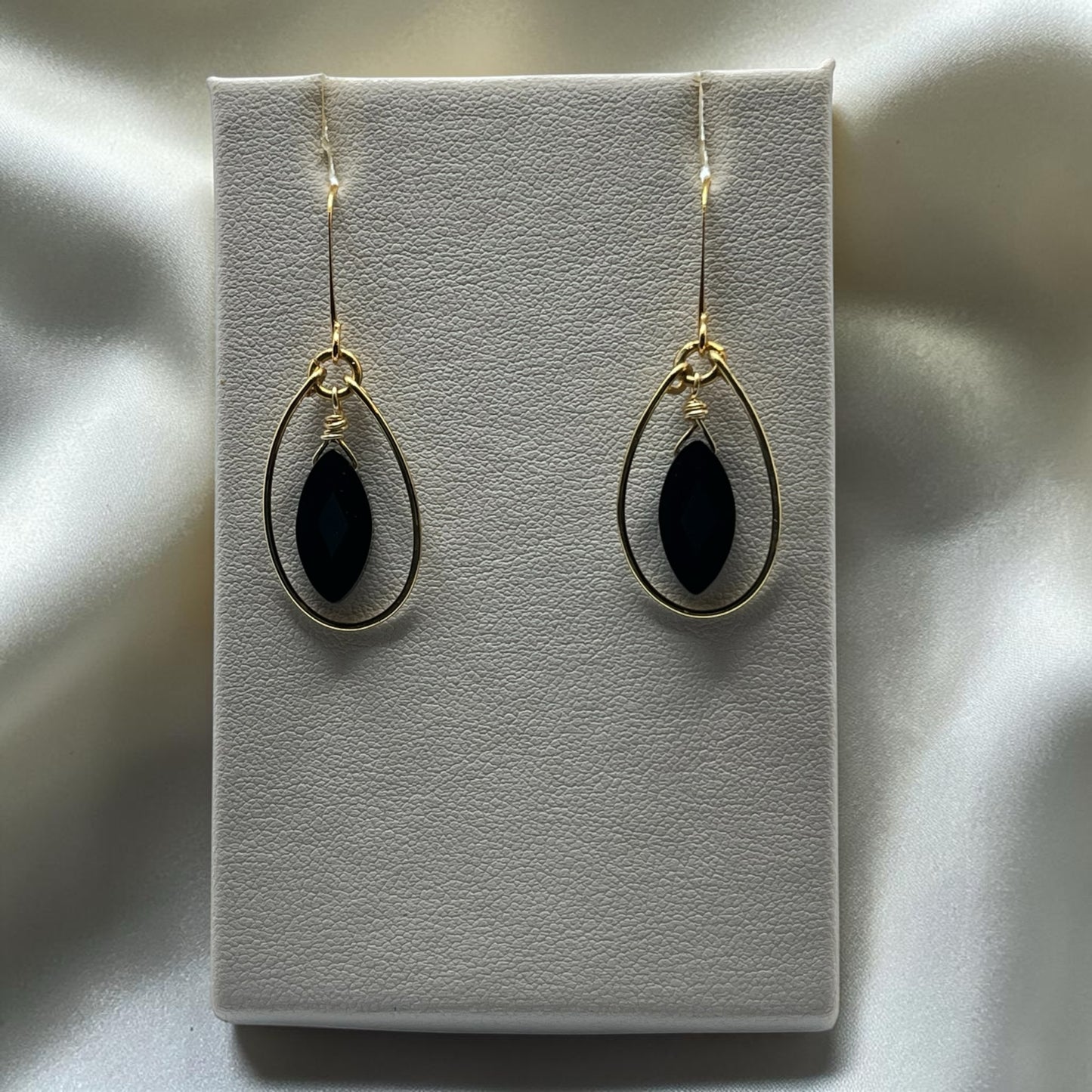 Blakeley Lane Jewelry gold-tone teardrop dangle earrings with marquise-cut black stones and wire-wrapped detail.