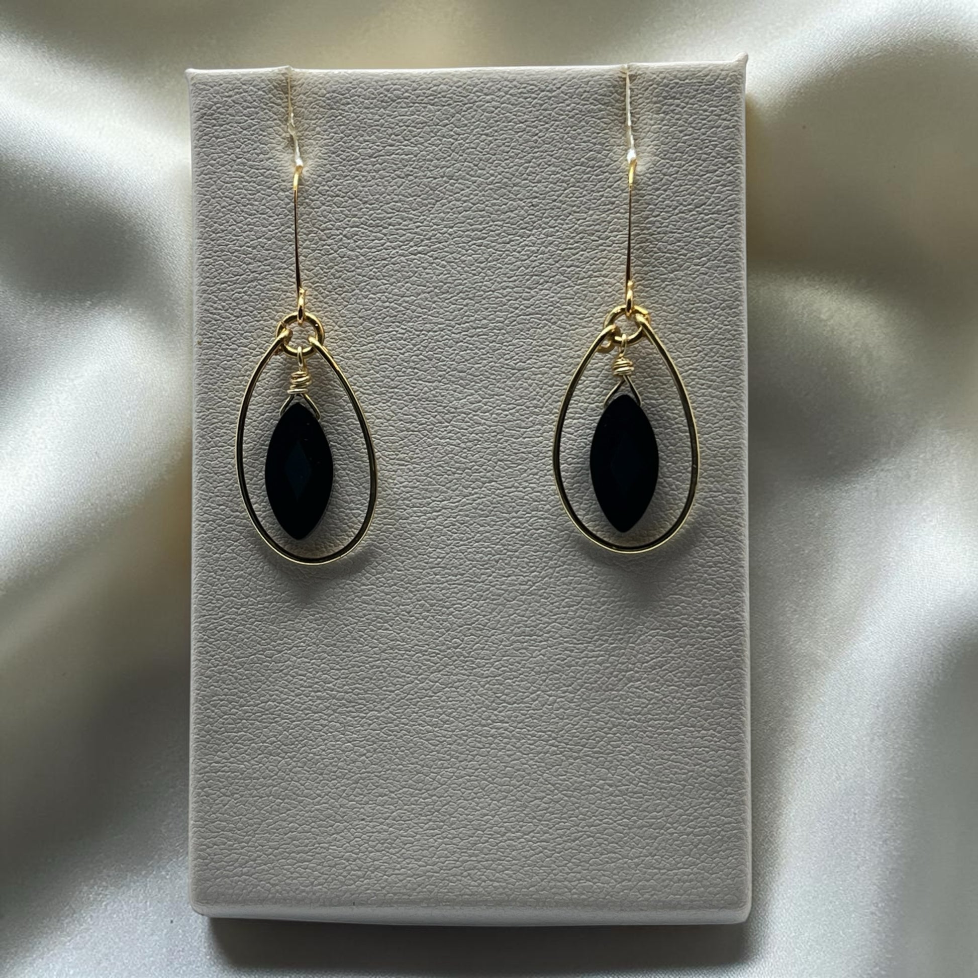Blakeley Lane Jewelry gold-tone teardrop dangle earrings with marquise-cut black stones and wire-wrapped detail.