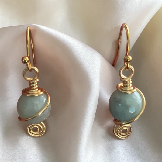 Blakeley Lane Jewelry handcrafted pale green gemstone dangle earrings with gold-toned wire wrapping and spiral detail.