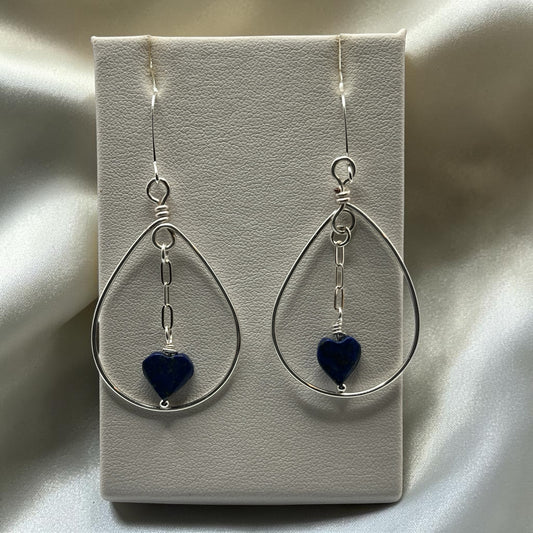 Blakeley Lane Jewelry handcrafted sterling silver teardrop earrings with blue lapis lazuli heart charms on display.