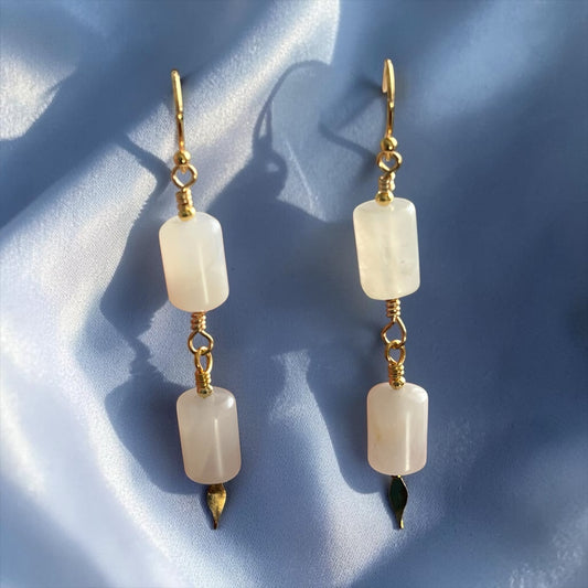 Blakeley Lane Jewelry double drop earrings with rectangular moonstone beads and gold-tone accents on blue silk.