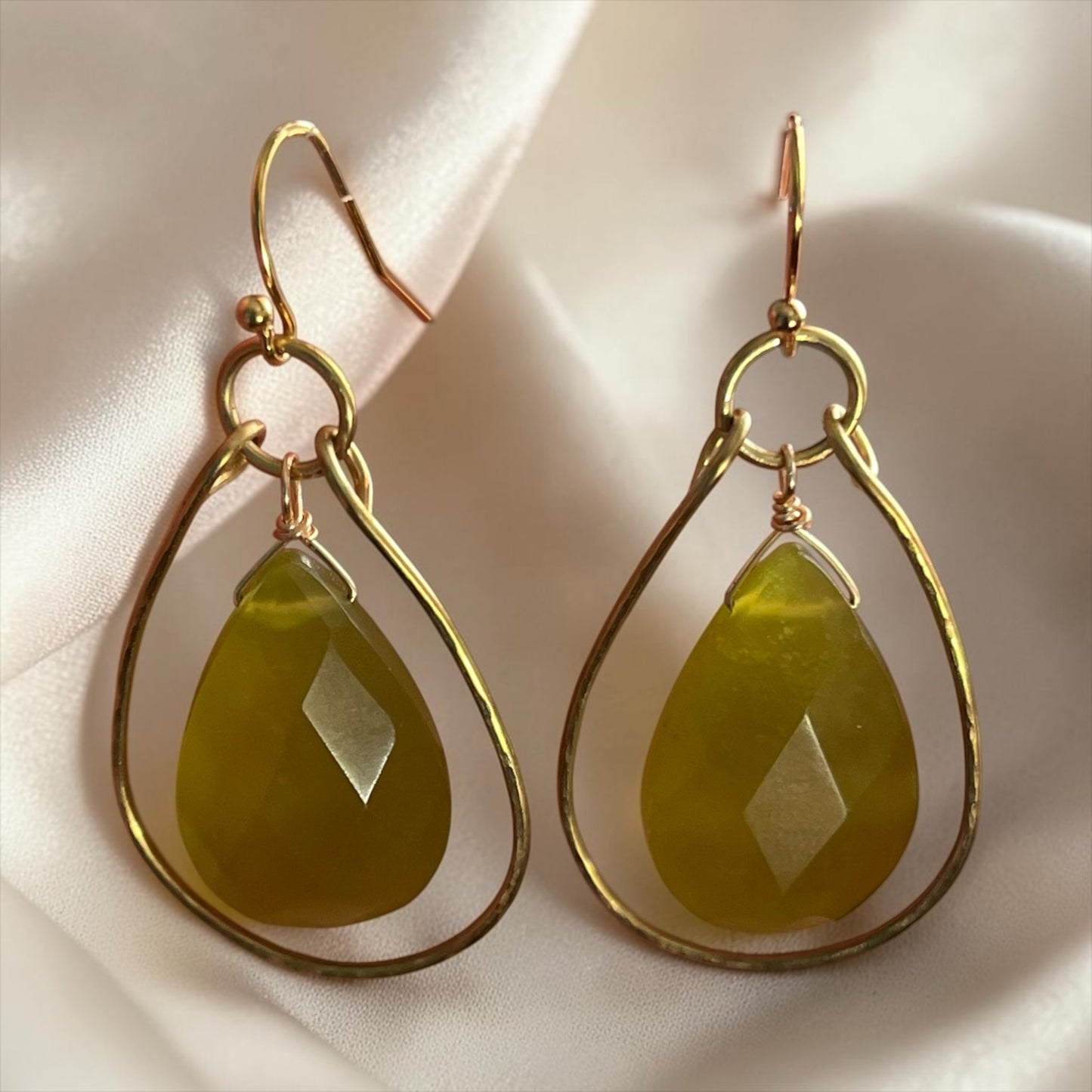 Blakeley Lane Jewelry teardrop earrings with faceted olive-green gemstones in hand-hammered gold-tone frames.