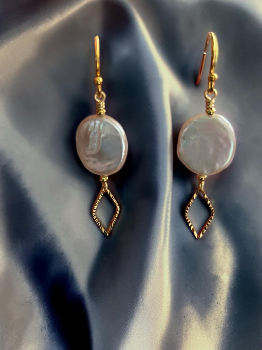 Blakeley Lane Jewelry coin pearl drop earrings with gold-tone diamond-shaped charms on a grey satin background.